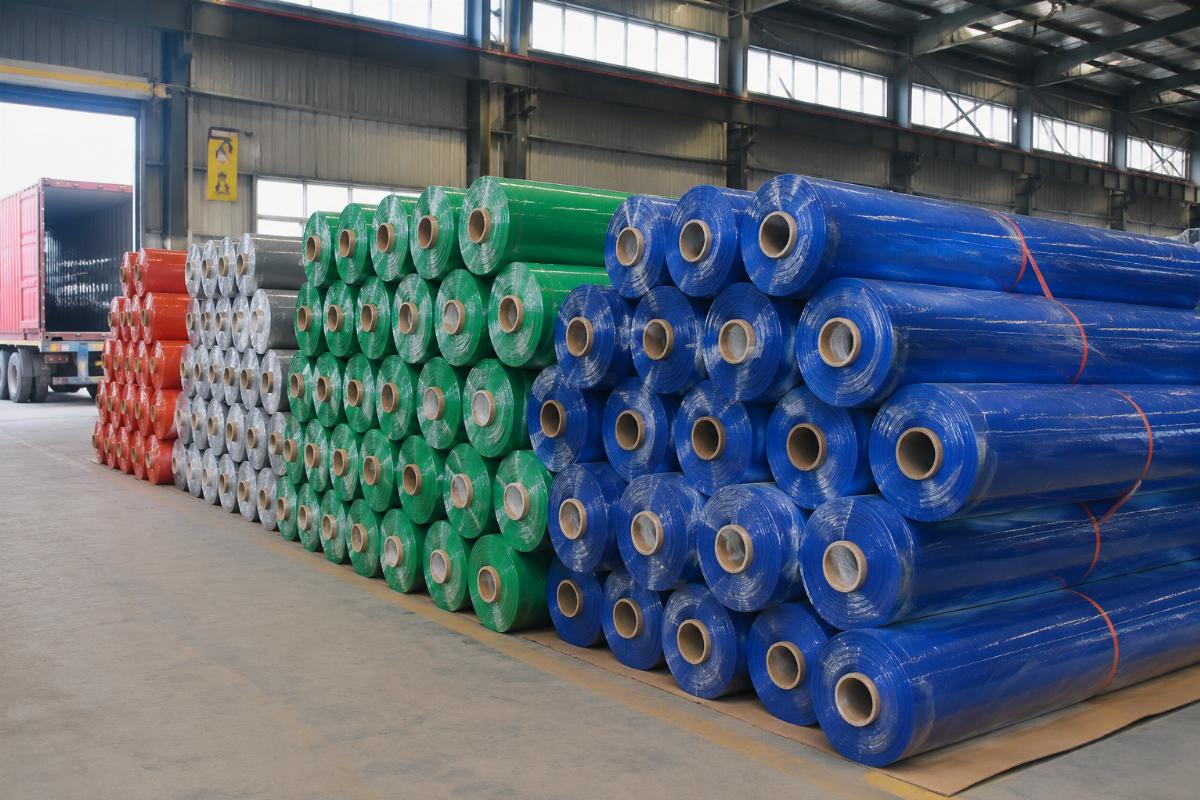Bulk PVC tarpaulin rolls ready for shipment from a Chinese manufacturing facility