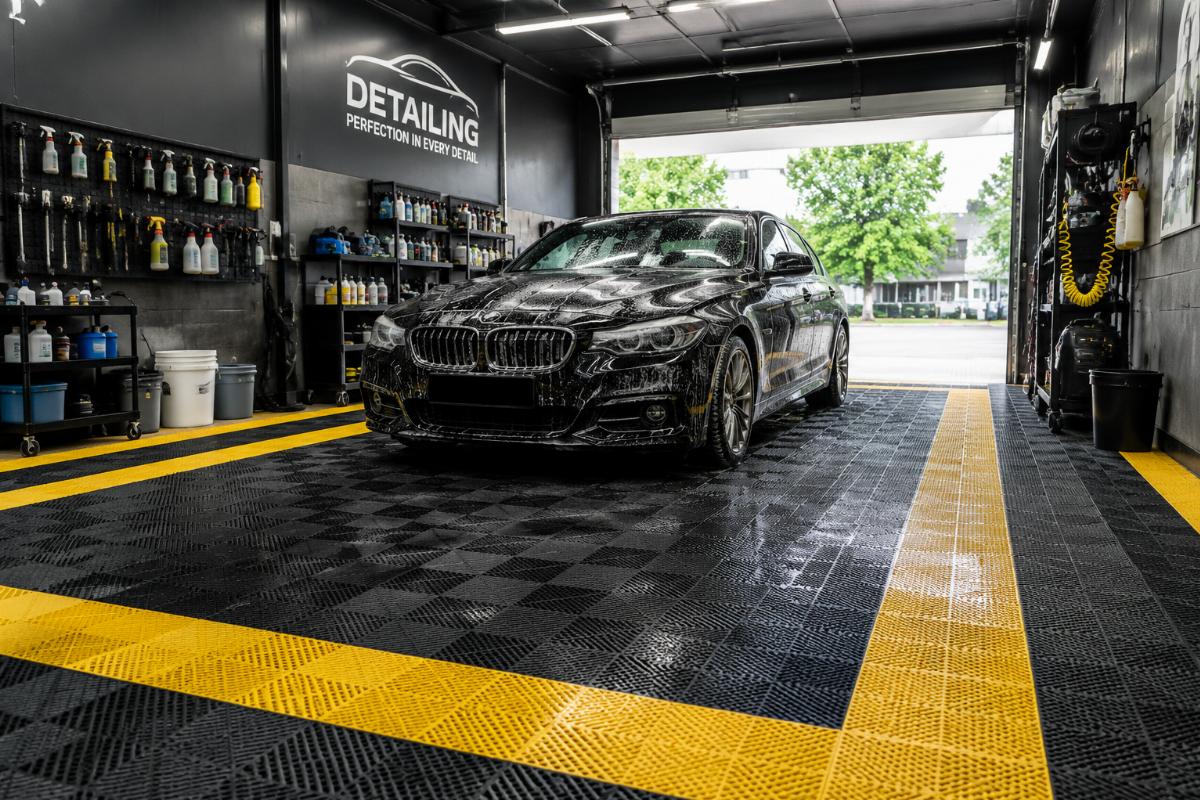 Commercial grade non-slip waterproof PVC car wash mats laid out in an auto detailing bay