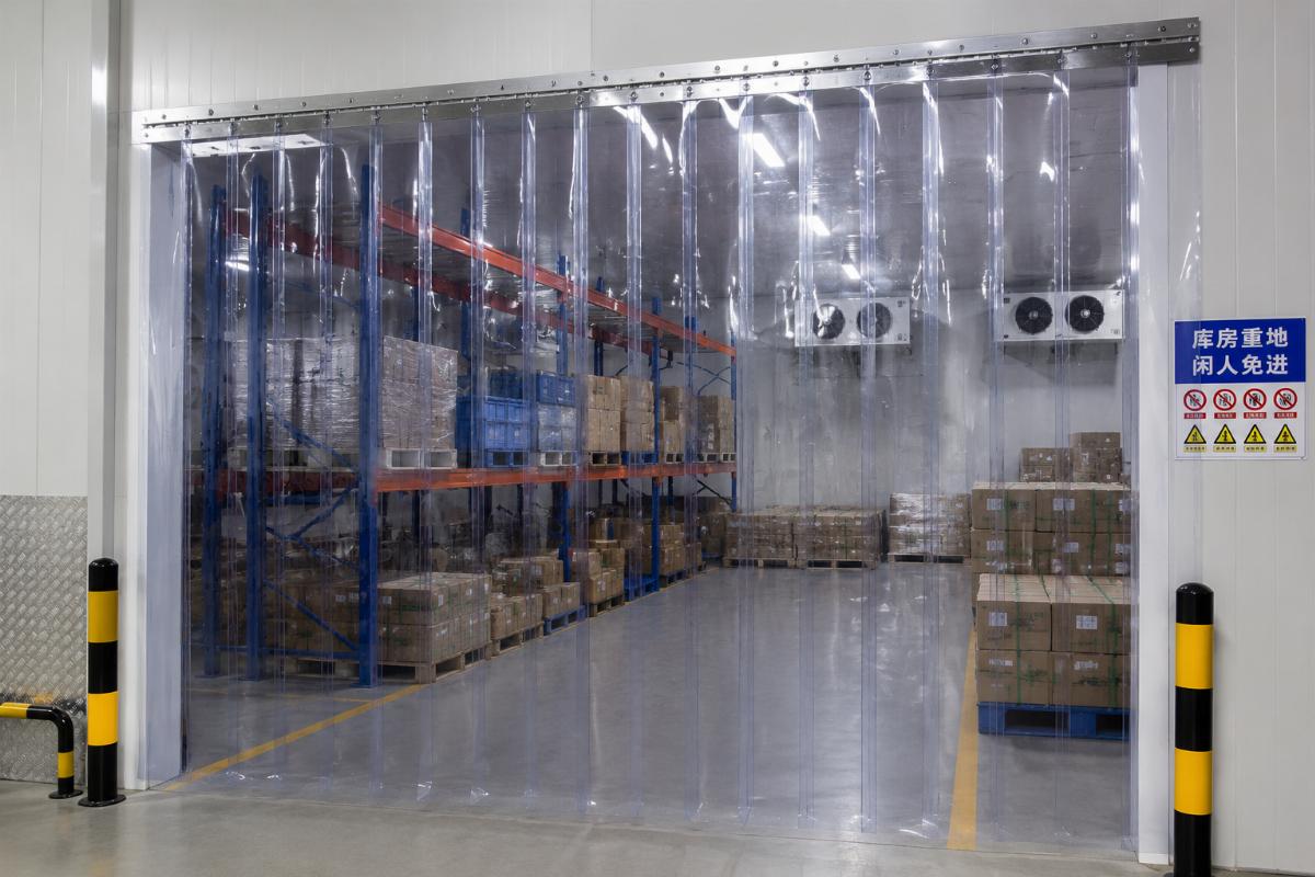 Finished food-grade PVC strip curtains in a warehouse storage area