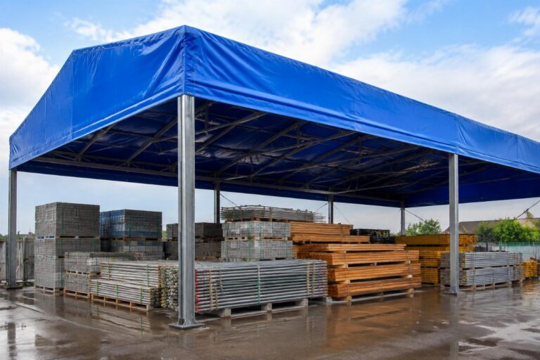 Open-air warehouse covered with high-quality PVC tarpaulin protecting stacked construction materials